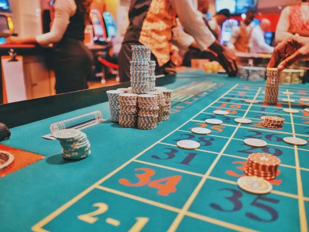 A roulette betting layout with stacks of chips placed on the numbers