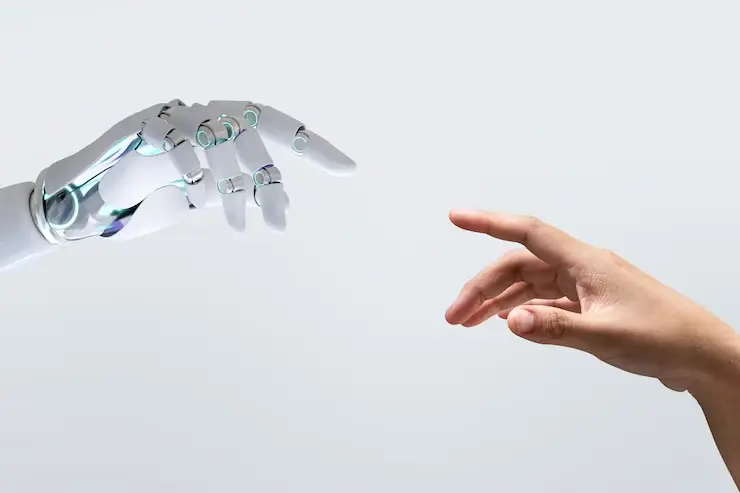 A robotic hand and a human hand reaching towards each other